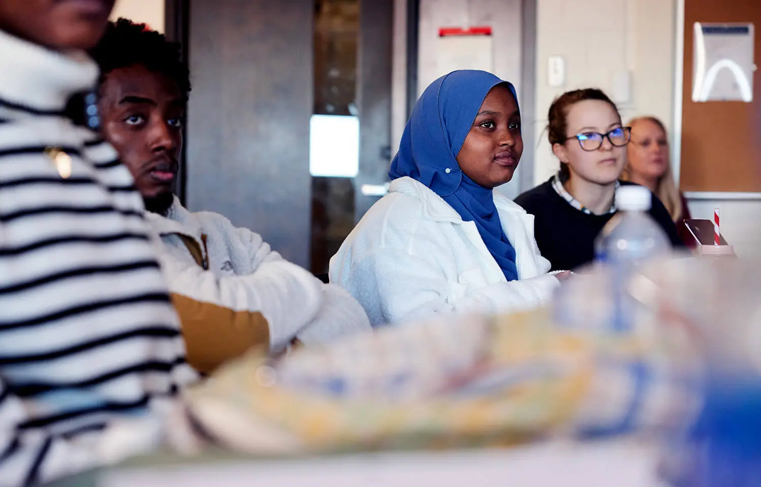 Students sitting in a class room.