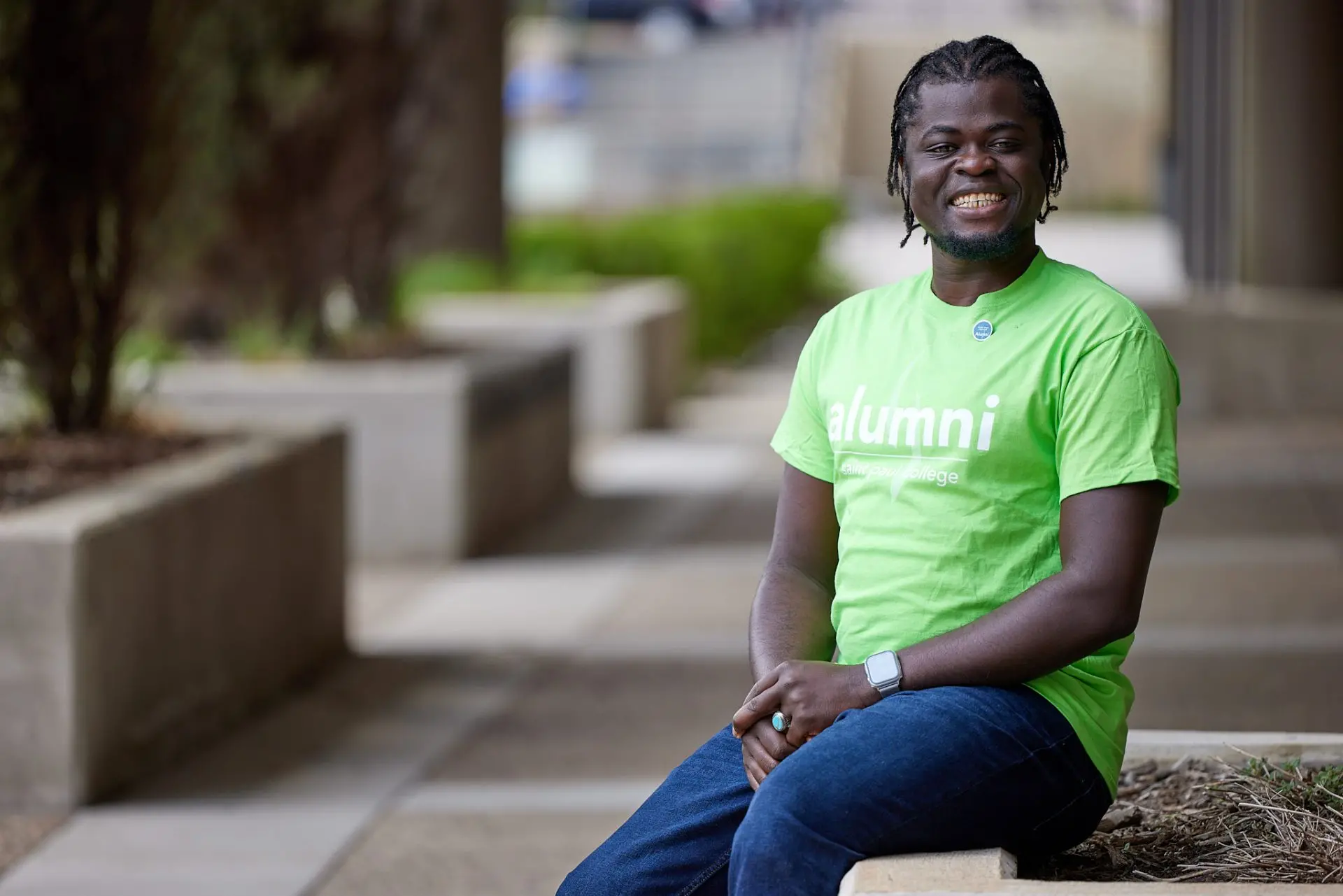 Picture of student wearing lime green alumni shirt