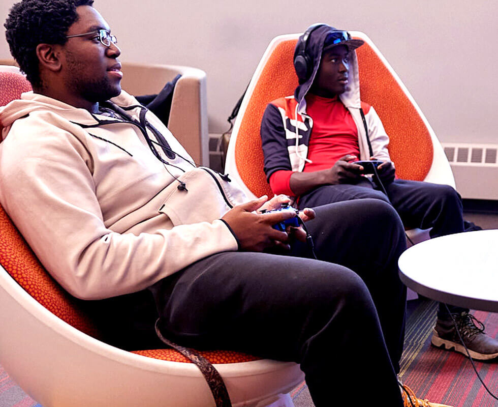 Students in the student life area playing video games.