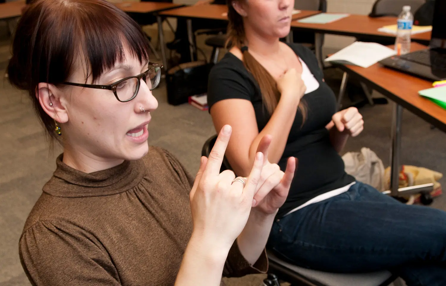 Photo of a student learning to sign in class.