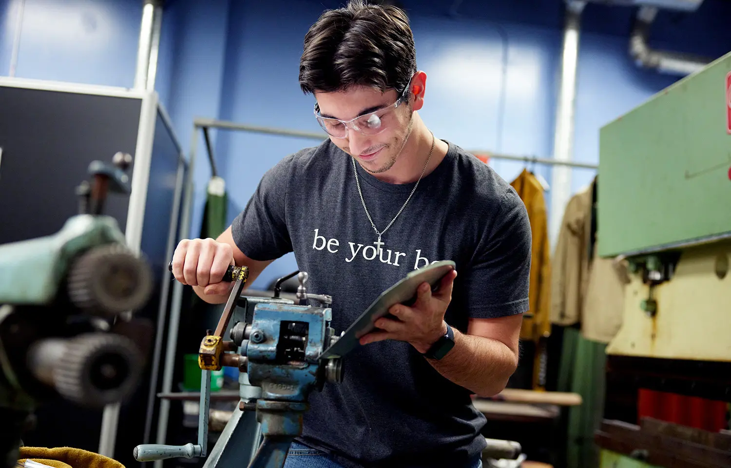 Photograph of a student in Sheet Metal class.