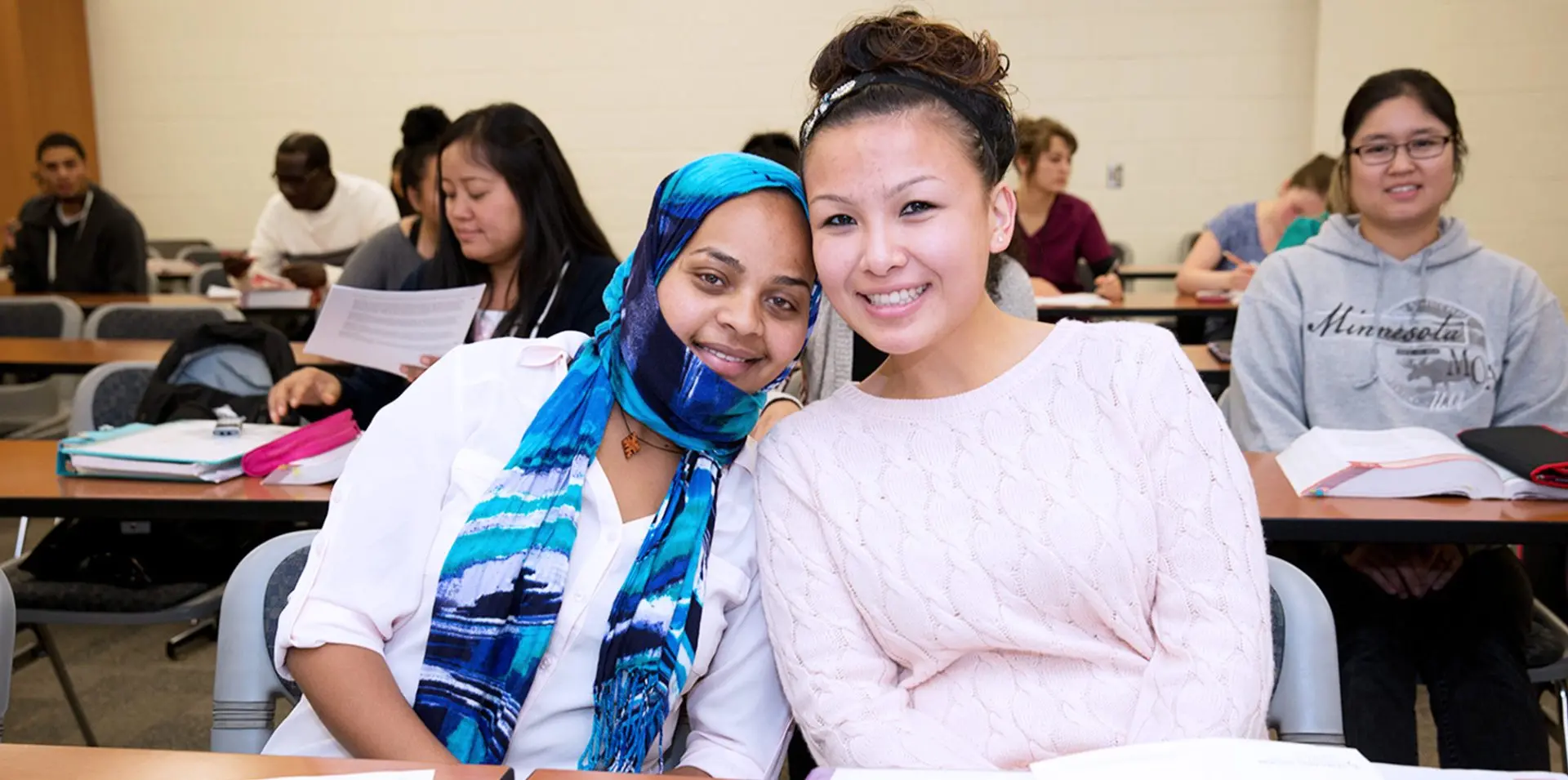 Photo of two Saint Paul College students in a classroom.