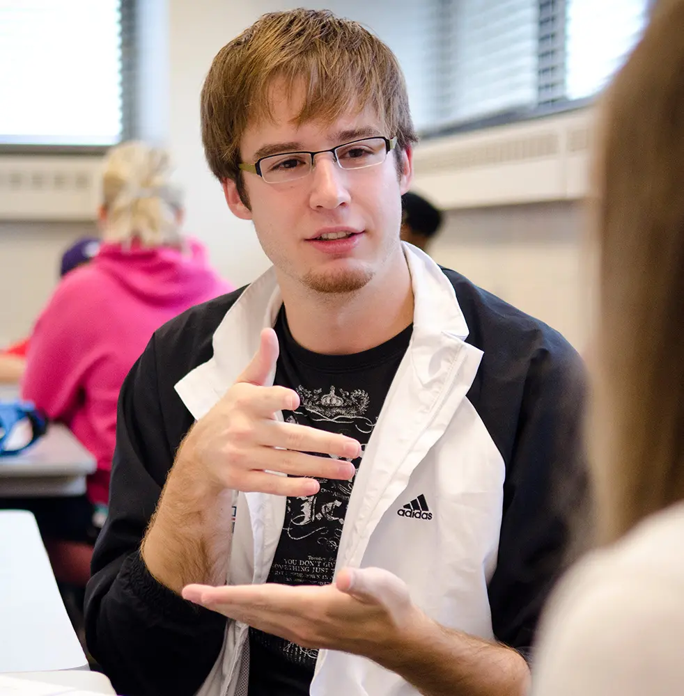 Photo of a student learning to sign in class.