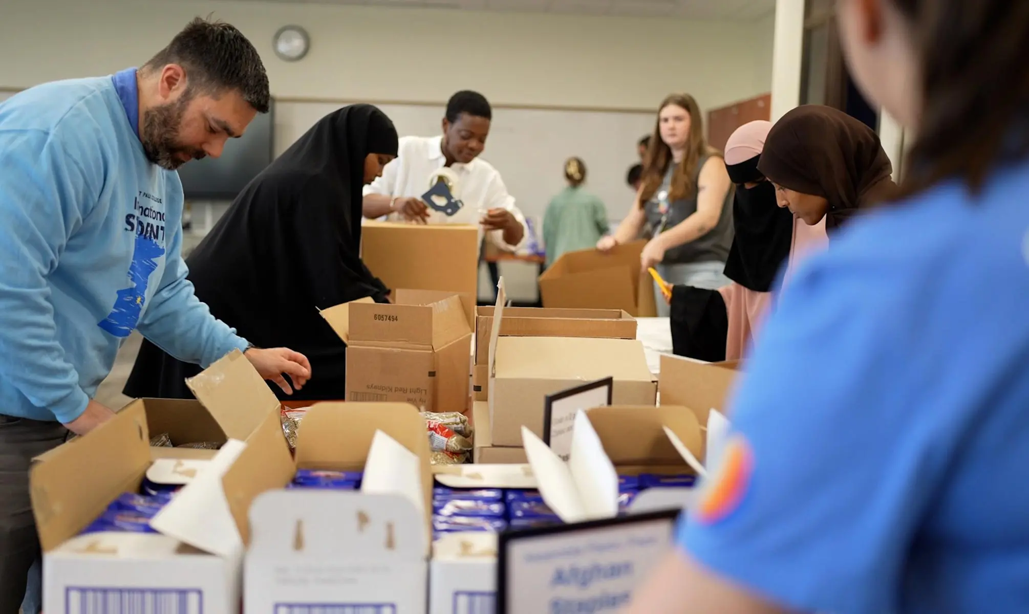 photo of VP Greg Rathert, staff, and students packing boxes