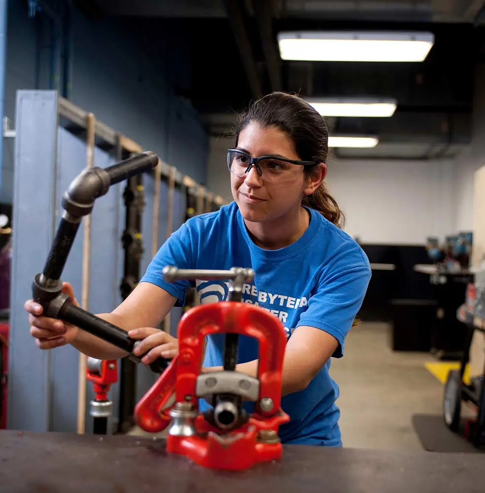 student working on pipe
