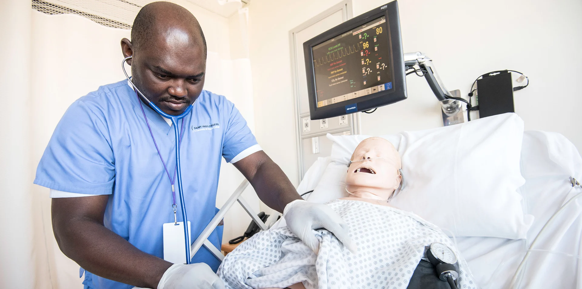 Adult student working on a mannequin in the sim center