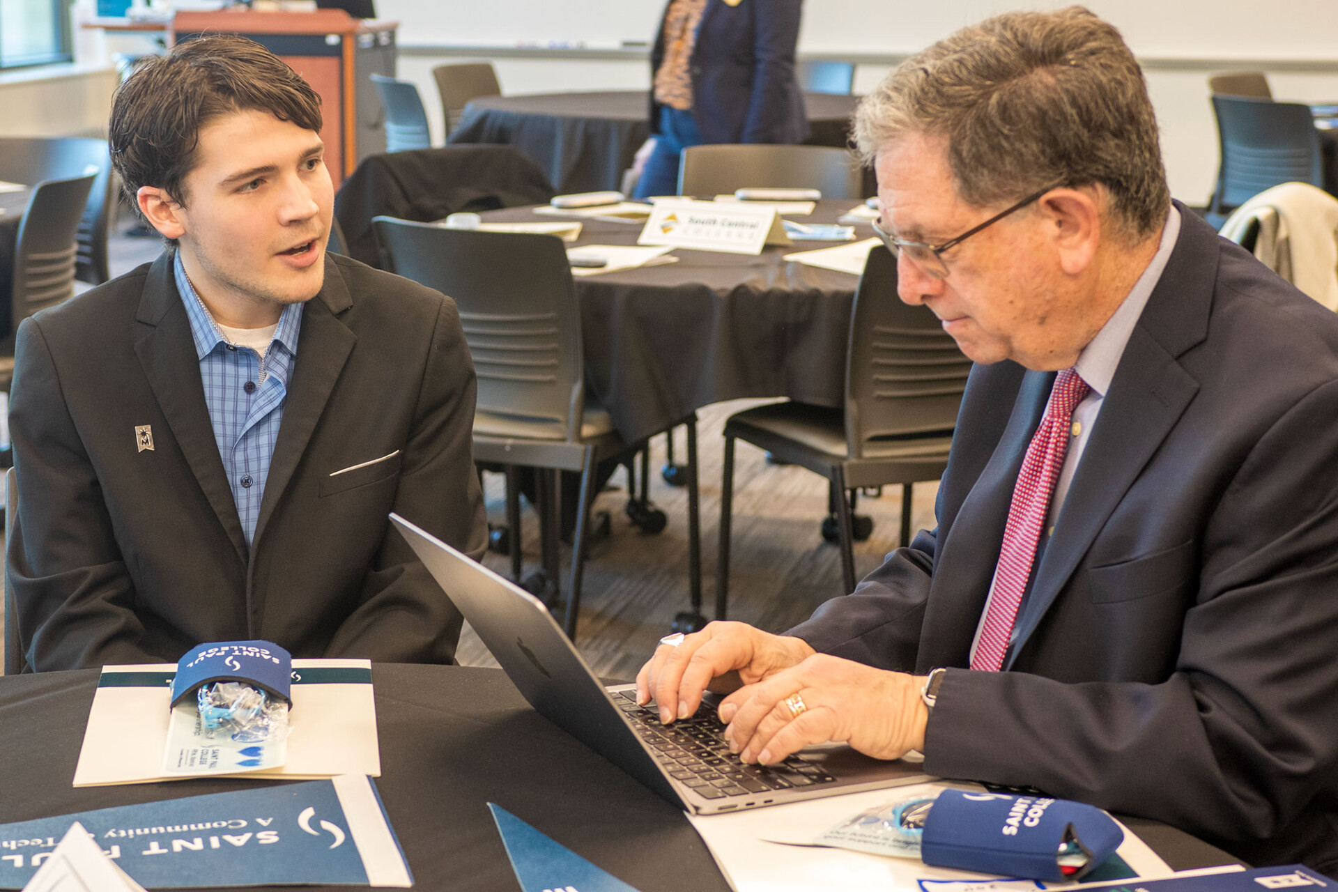 Board of Trustees member speaking to reporter