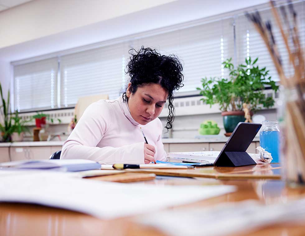 student painting on paper