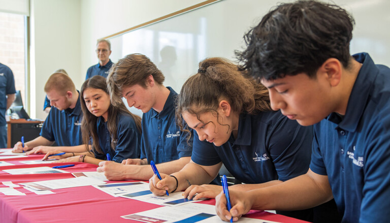 SPC Students Signing at a table