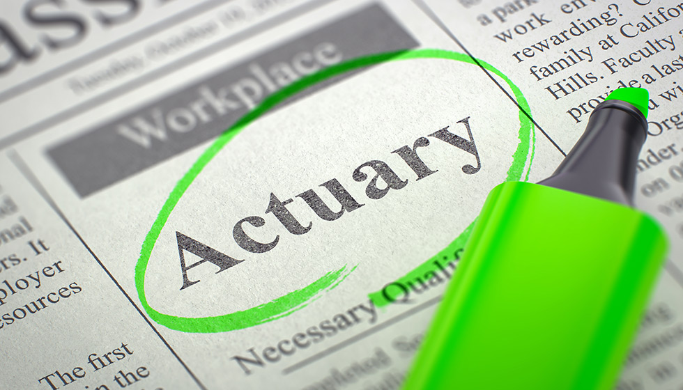 newspaper with the word actuary circled in green with a green highlighter sitting on top