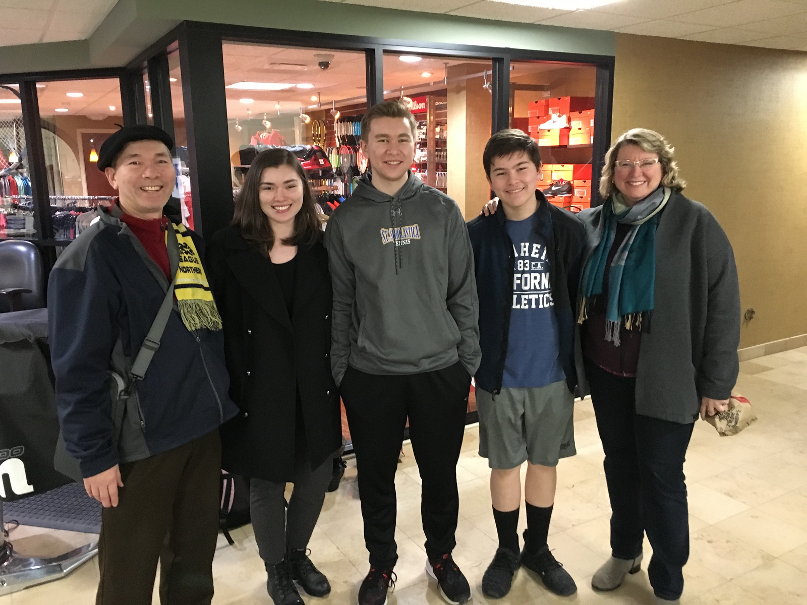 Francois Nguyen with students in a hallway