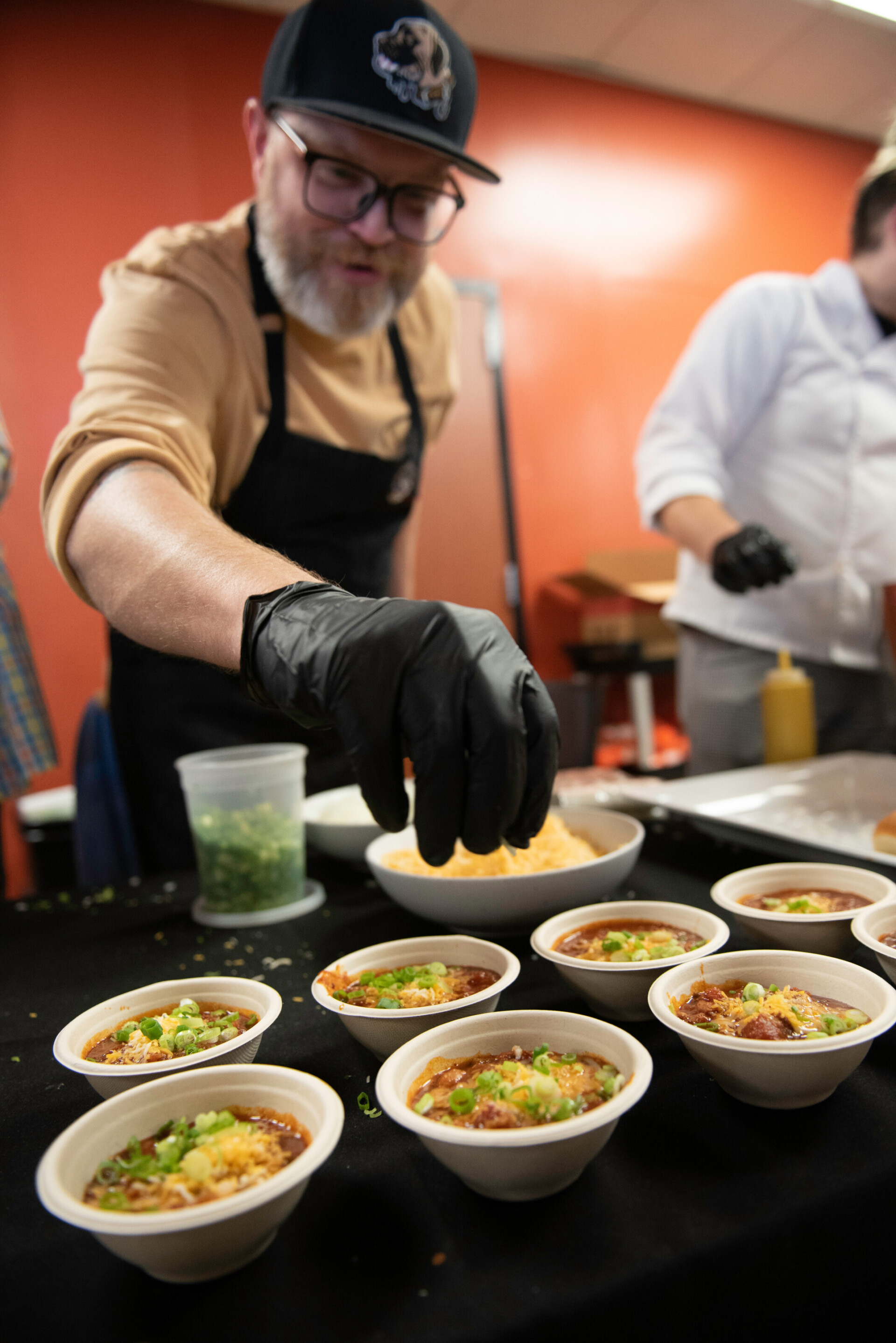 chef putting the finishing touches on the chili