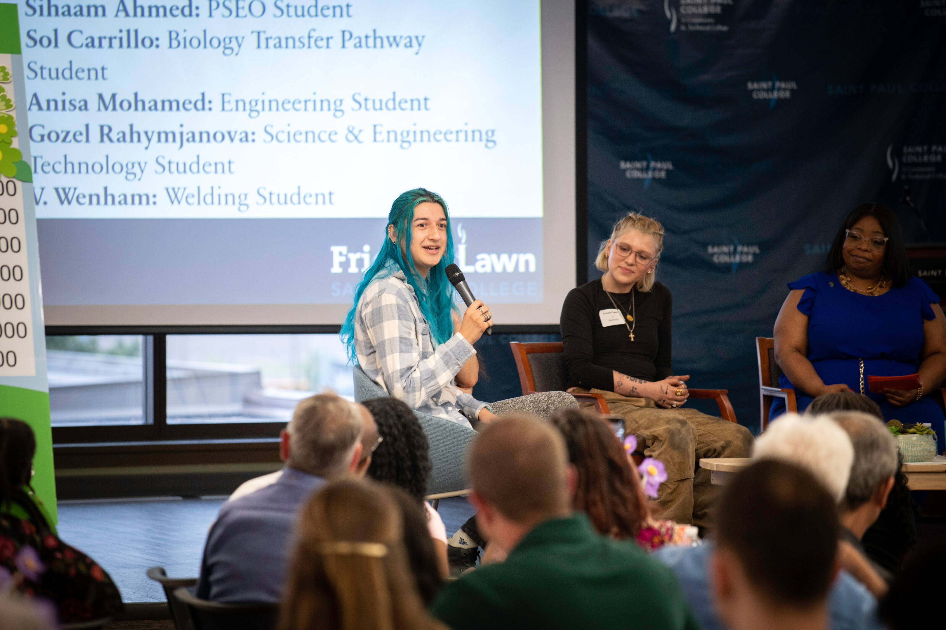 Two students on a panel at a campus event.