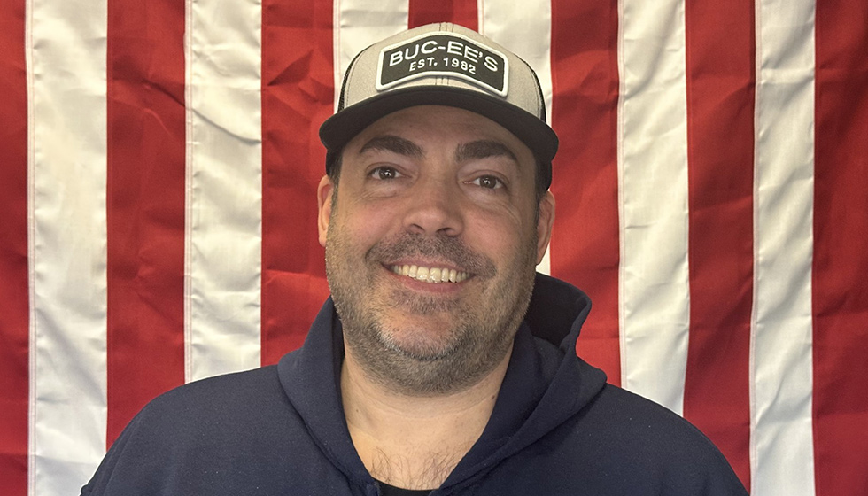 Greg Lawrence in front of an American Flag