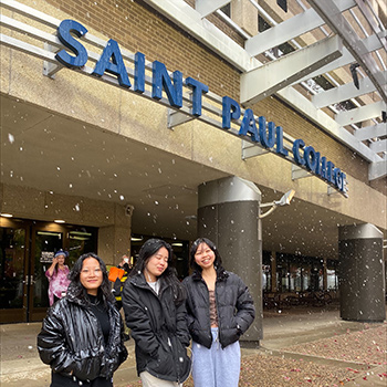 3 people posing in front of Saint Paul College
