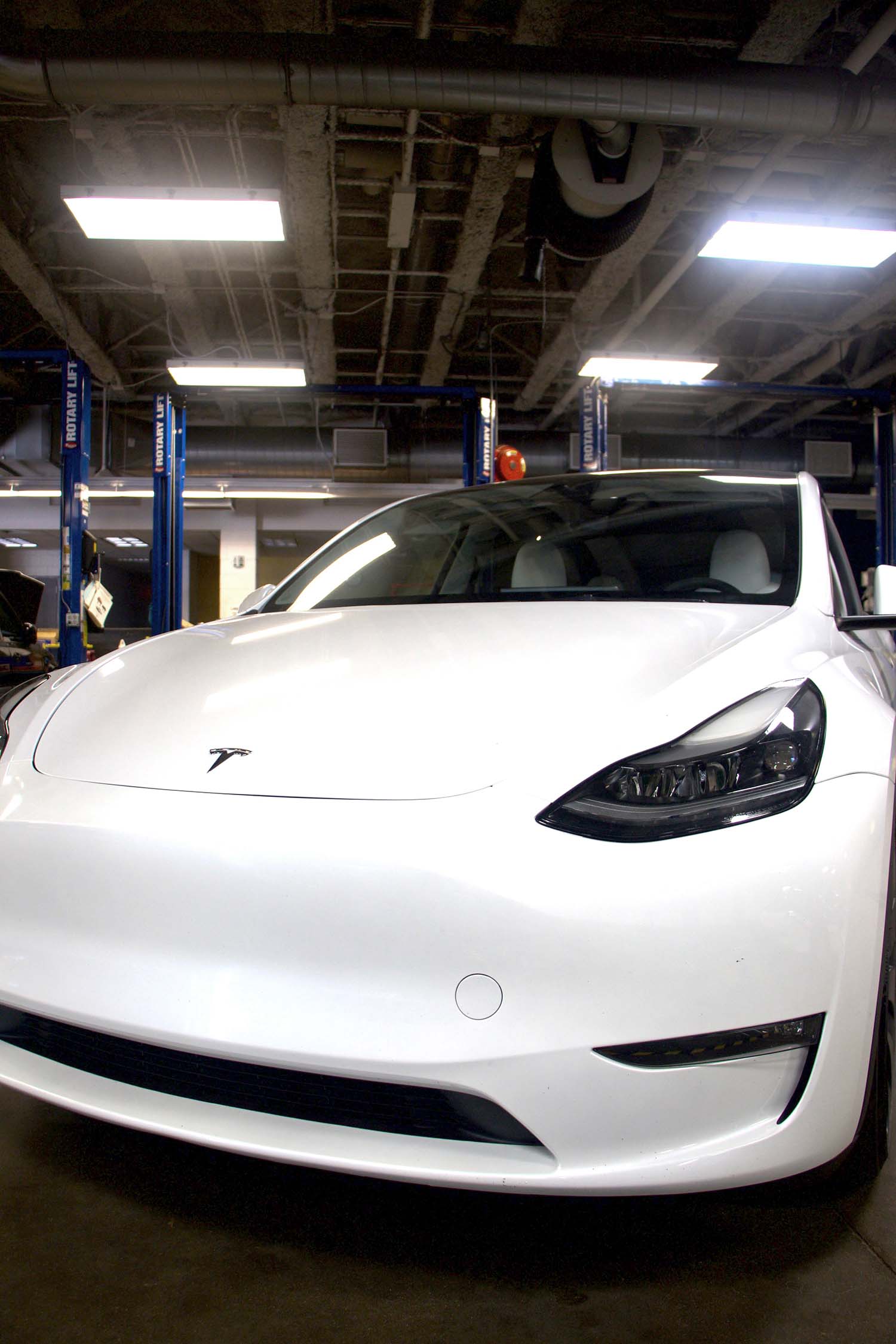 Front view of Tesla Model Y used in hands-on EV training program in automotive shop