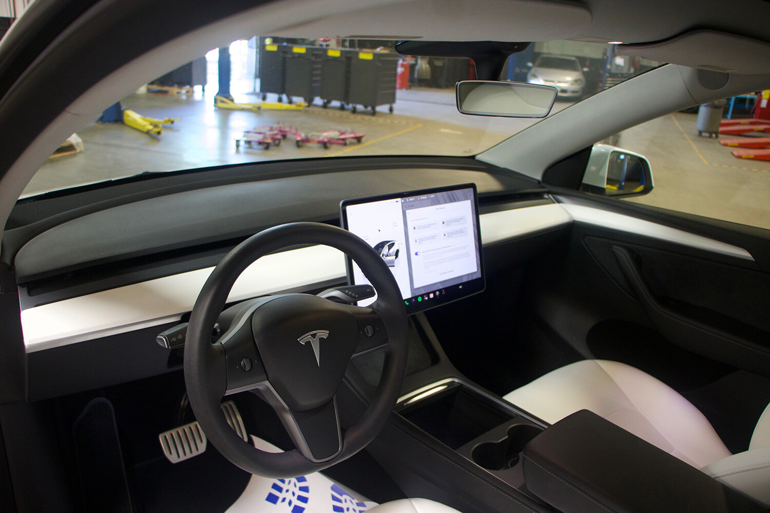 Tesla Model Y interior in EV training lab showing touchscreen and controls for electric vehicle technician training