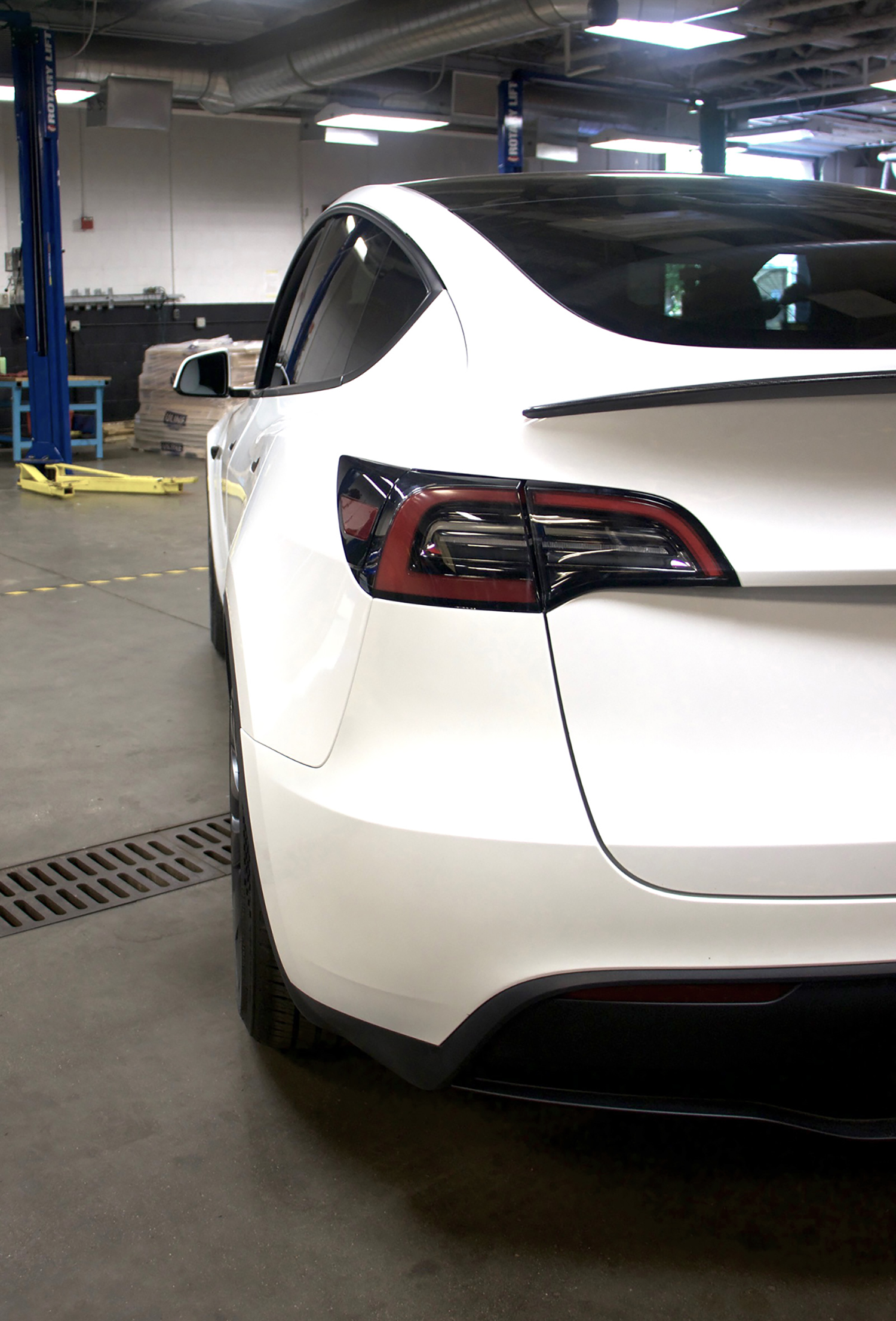 Rear view of Tesla Model Y in EV technician training lab for real-world electric car repair skills