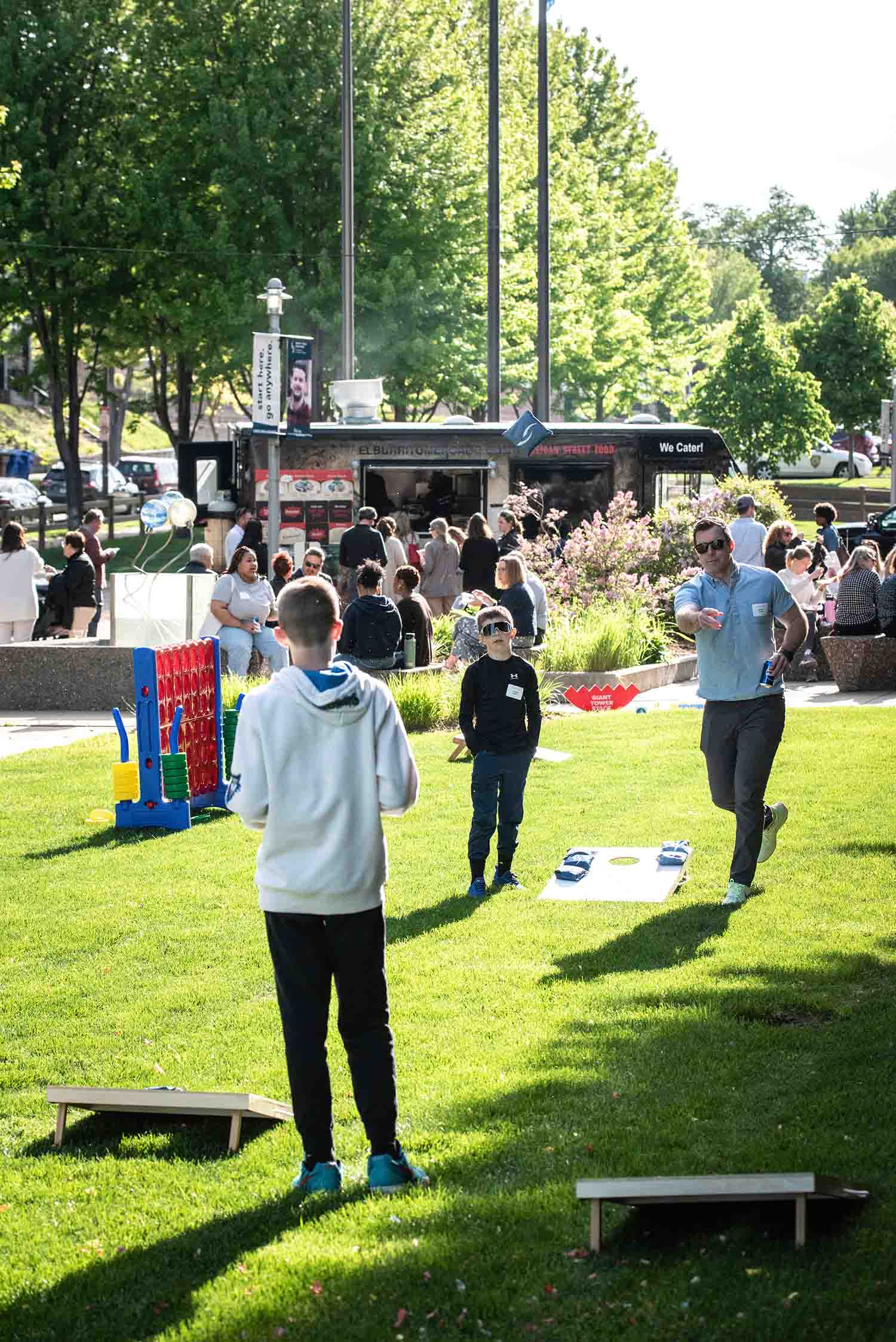 Guests playing lawn games and enjoying food trucks at Friends on the Lawn 2026 Saint Paul College
