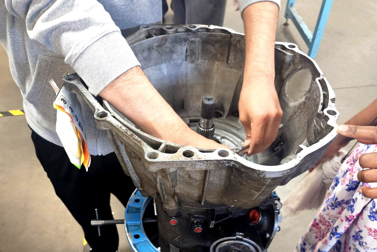 High school students hands inside a part of of a car.