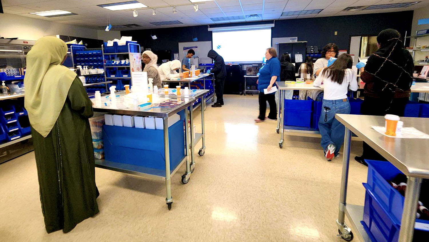High school students participate in pharmacy lab activity at Saint Paul College, sorting and preparing medications during hands-on training