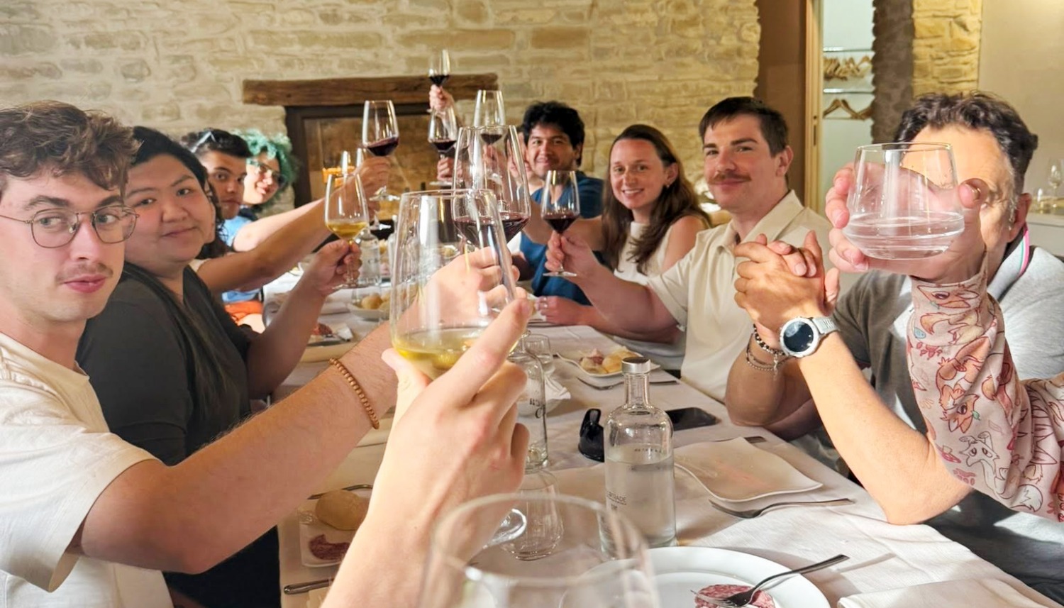 Culinary students study abroad Italy enjoying traditional Italian meal and wine tasting during immersive culinary arts and cultural experience program