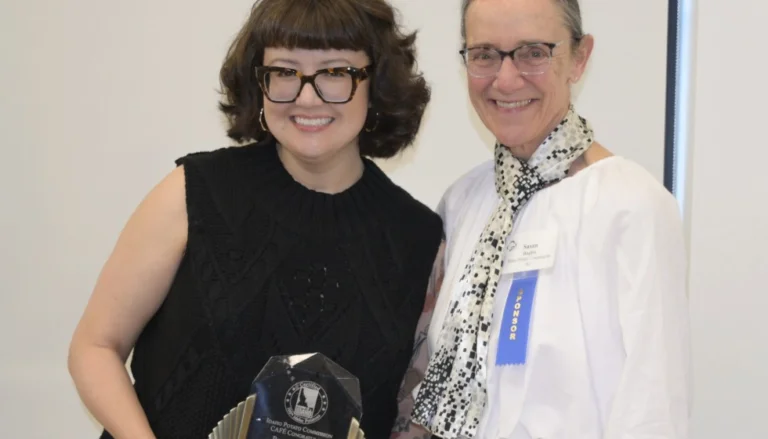 Sara Johannes, chef instructor and culinary arts department chair at Saint Paul College, receives the national 2026 Postsecondary Educator of the Year award from Susan Hughes, Idaho Potato Commission.