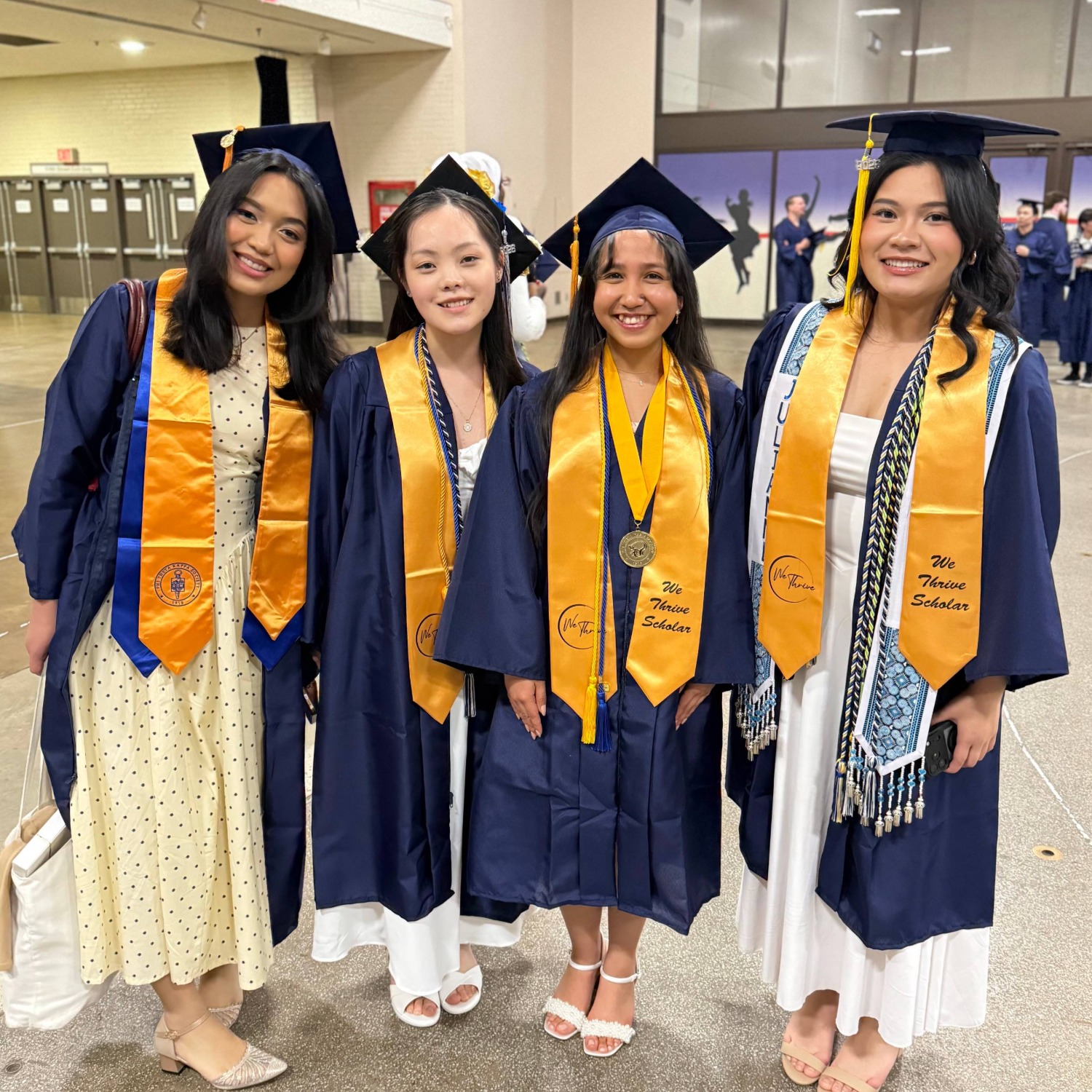 4 We Thrive students in cap and gown at the Saint Paul College 2025-2026 graduation.