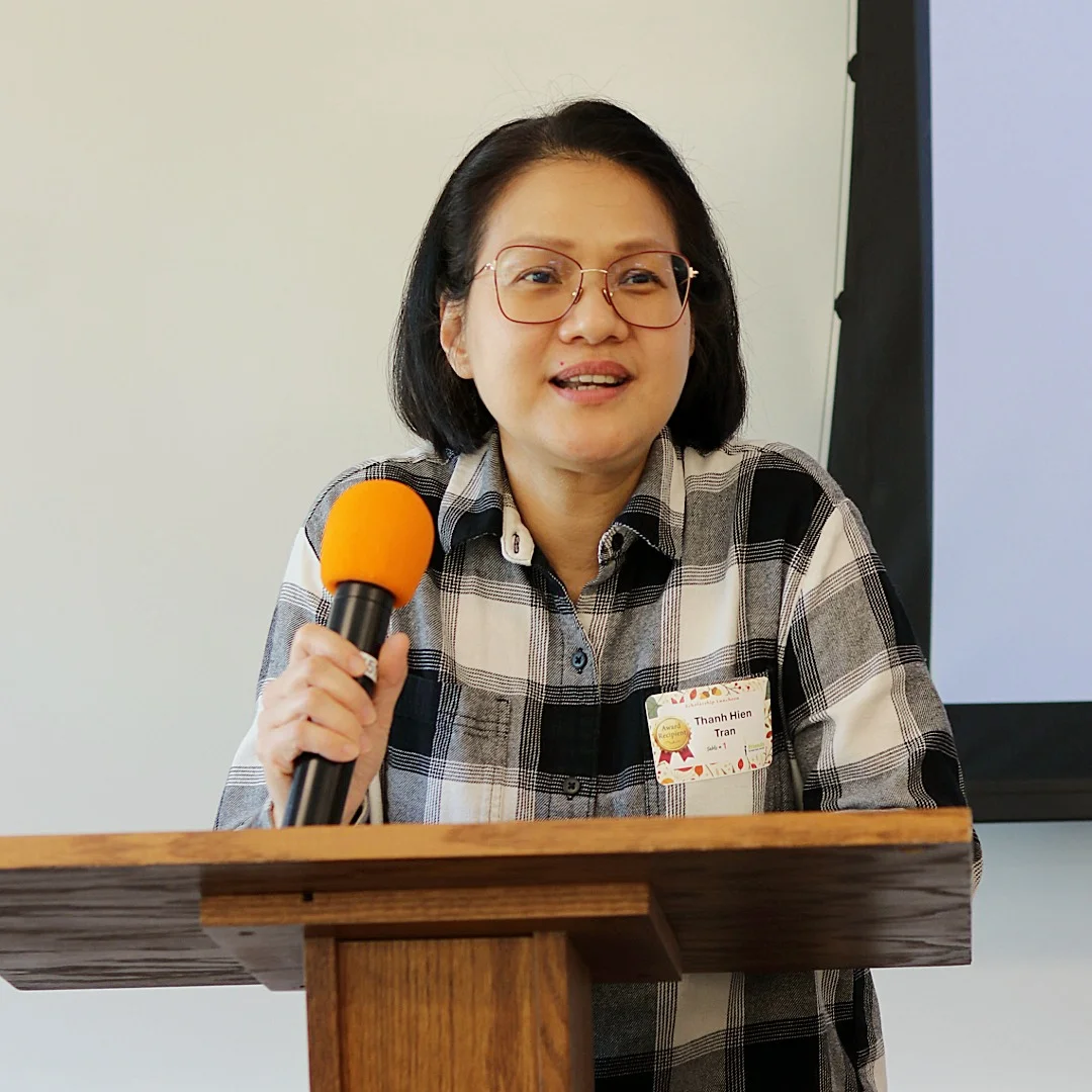 Student speaker, Thanh Hien Tran, speaking at a podium